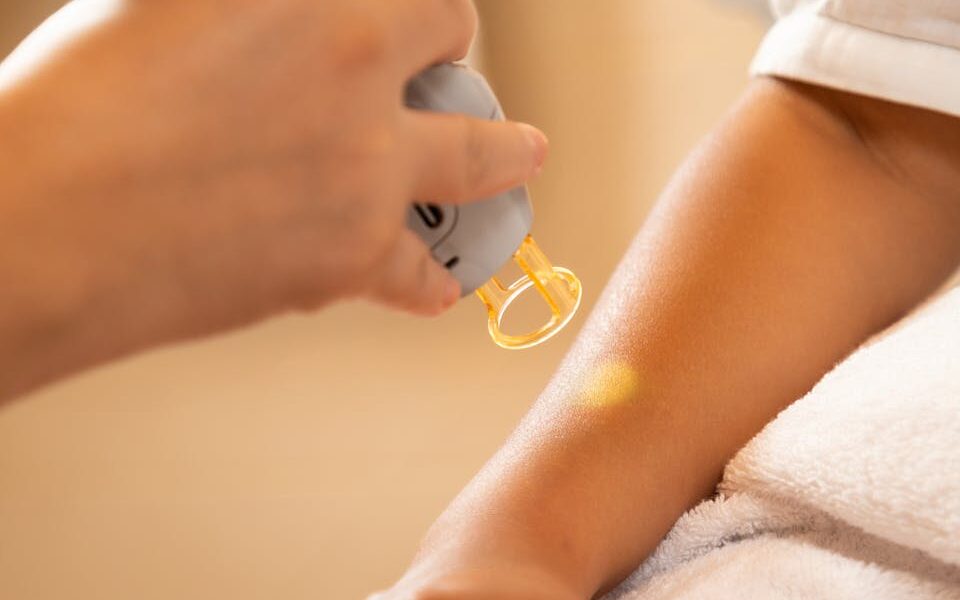 Laser hair removal in the beauty salon. Woman having professional laser epilation procedure of arm